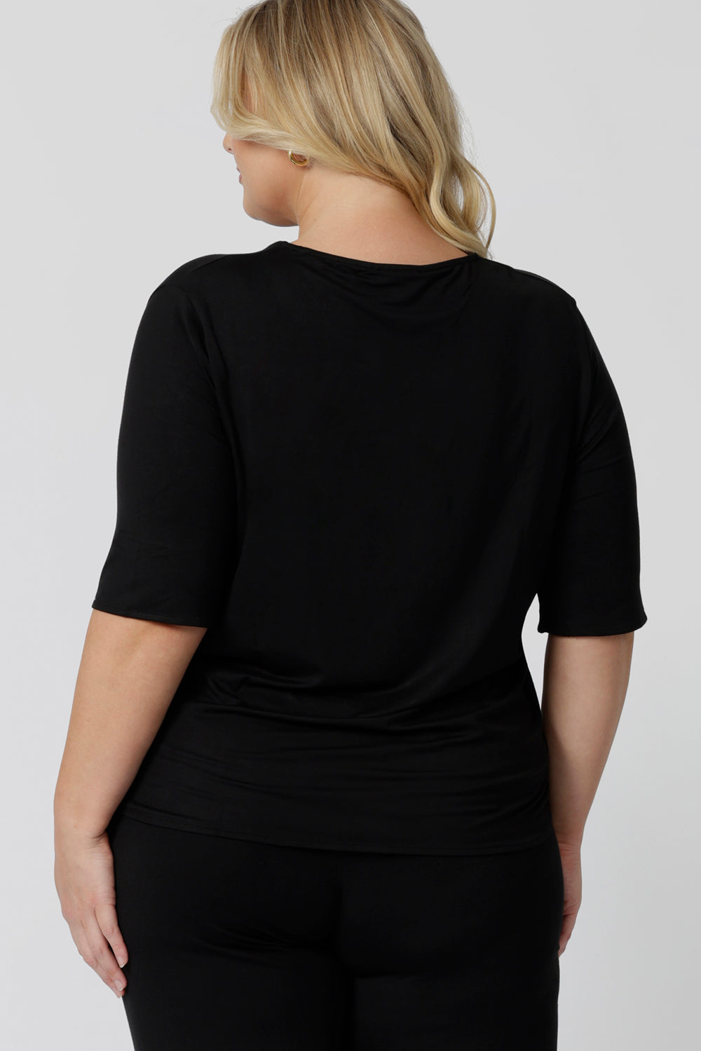 Back view of a sleepwear slouchy tee top, a size 18 woman wears a plus size lounge top in black bamboo. A 3/4 top with high neck, this lounge top is breathable and thermo-regulating so it make good pyjamas for night sweats and hot flushes. Shop loungewear and sleepwear in sizes 8 to 24 online at L&F Australia.