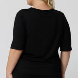 Back view of a sleepwear slouchy tee top, a size 18 woman wears a plus size lounge top in black bamboo. A 3/4 top with high neck, this lounge top is breathable and thermo-regulating so it make good pyjamas for night sweats and hot flushes. Shop loungewear and sleepwear in sizes 8 to 24 online at L&F Australia.