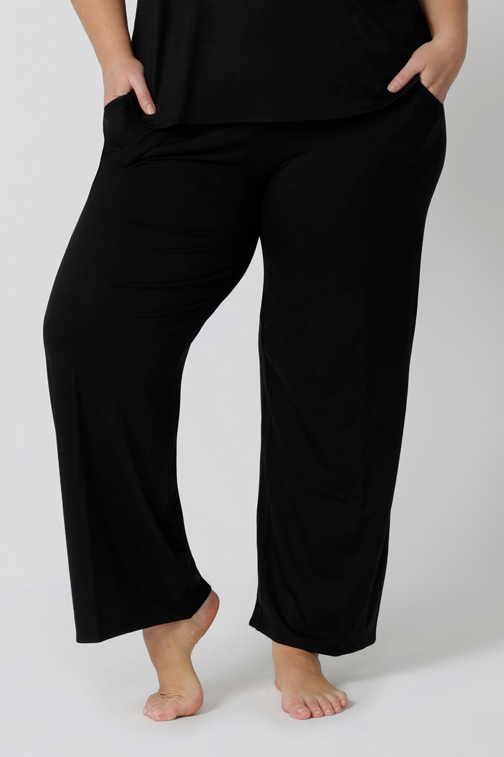 Close up of a size 18 woman wearing straight, wide leg black bamboo lounge pants. Thermo-regulating and breathable this is a great pyjama set for night sweats and hot flushes. Shop plus size lounge and sleepwear online at L&F Australia.