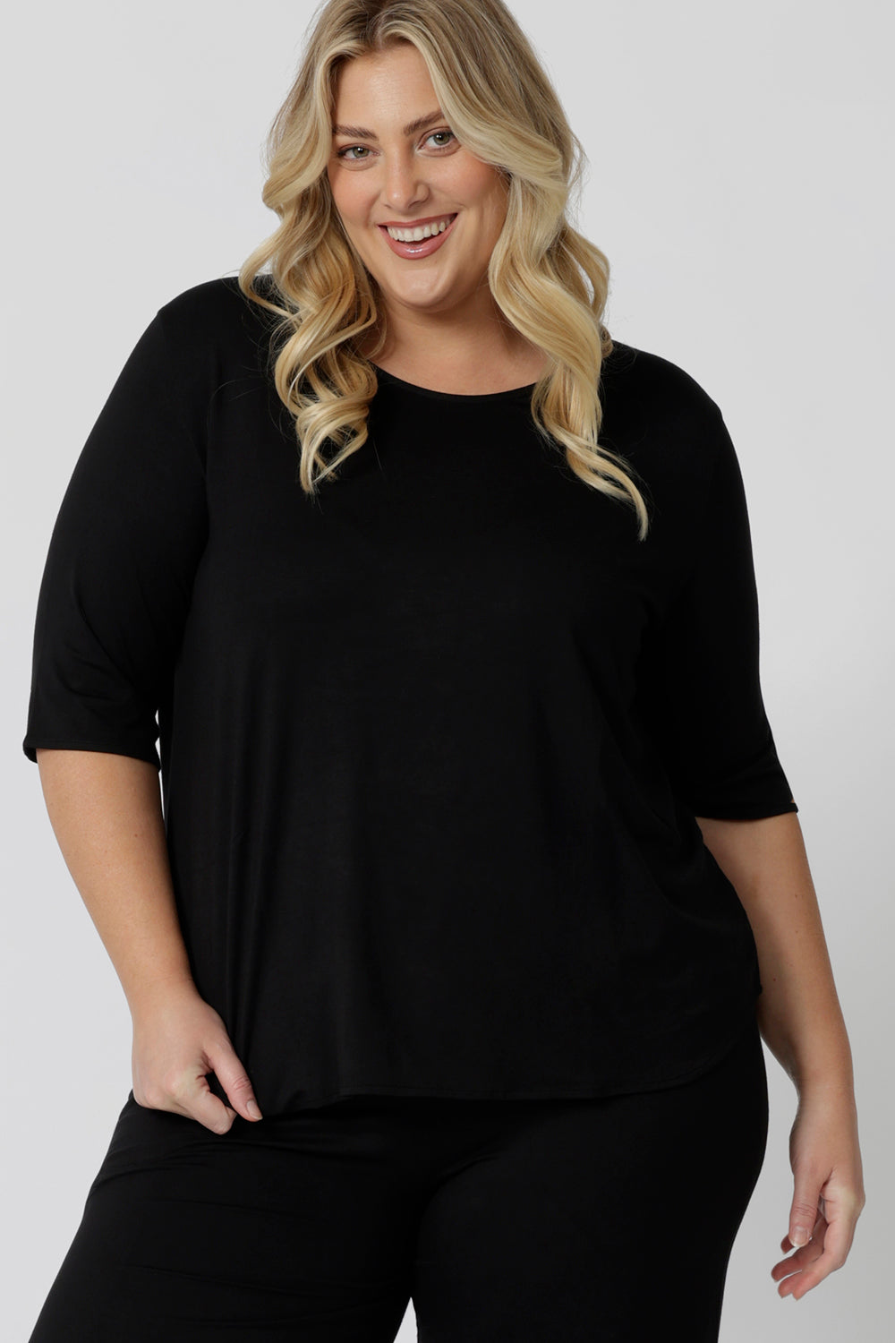 Showing a sleepwear slouchy tee top, a size 18 woman wears a plus size lounge top in black bamboo. A 3/4 top with high neck, this lounge top is breathable and thermo-regulating so it make good pyjamas for night sweats and hot flushes. Shop lounge and sleepwear in sizes 8 to24 online at L&F Australia.