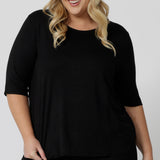 Showing a sleepwear slouchy tee top, a size 18 woman wears a plus size lounge top in black bamboo. A 3/4 top with high neck, this lounge top is breathable and thermo-regulating so it make good pyjamas for night sweats and hot flushes. Shop lounge and sleepwear in sizes 8 to24 online at L&F Australia.