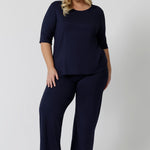 Showing good lounge pants for curvy women, a size 18 wears straight, wide leg navy blue, plus size lounge pants in bamboo jersey with a navy blue, slouchy tee top. Breathable and thermo-regulating this is a good pyjama set  for night sweats and hot flushes. Stay cool for summer nights with breathable sleepwear by L&F Australia in sizes 8-24.