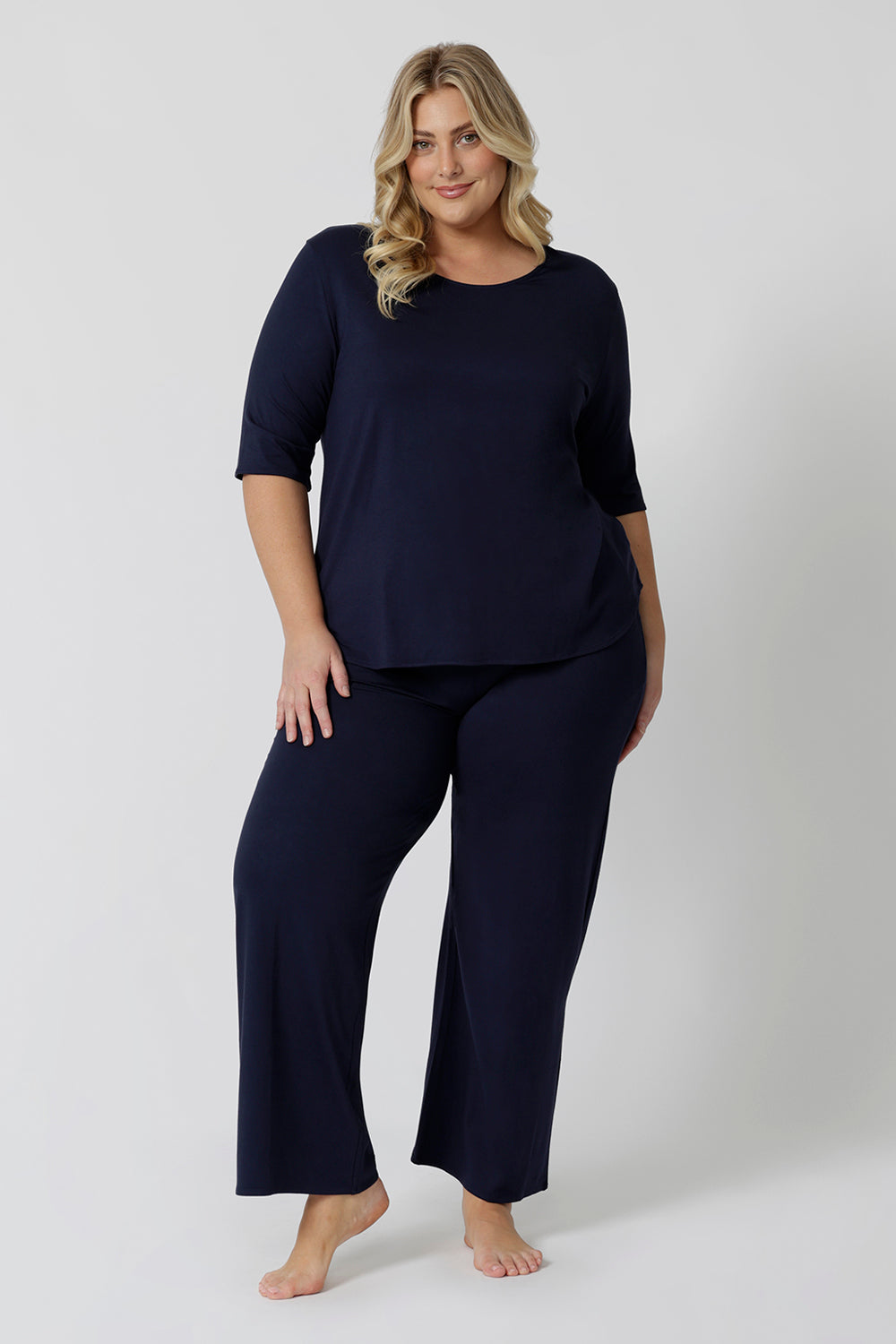 Showing good lounge pants for curvy women, a size 18 wears straight, wide leg navy blue, plus size lounge pants in bamboo jersey with a navy blue, slouchy tee top. Breathable and thermo-regulating this is a good pyjama set  for night sweats and hot flushes. Stay cool for summer nights with breathable sleepwear by L&F Australia in sizes 8-24.