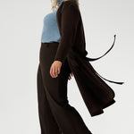 Engineered for effortless wear, it resists creasing and is easy to care for, making it the perfect travel companion. Thoughtfully tailored with clean front panels and discreet seam pockets, it features a chic grown-on neckline, elegant two-piece long sleeves, and a subtly structured waist seam at the back.