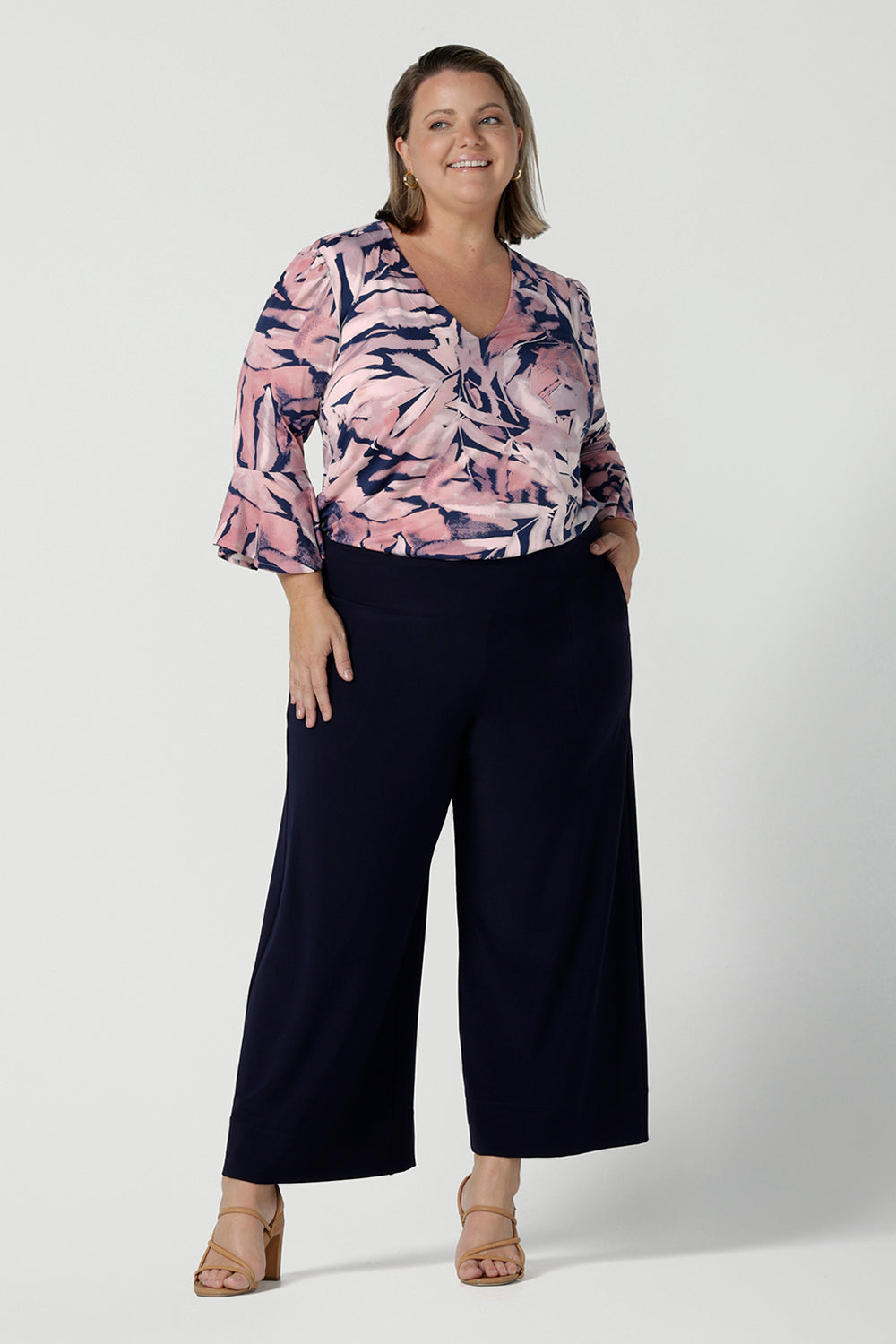 A size 18 woman wears the Tahlia top in Cantata. Fluted sleeves and a v-neckline. A great V-neckline top with 3/4 sleeves. Soft slinky jersey perfect for comfortable workwear for women size 8 - 24.