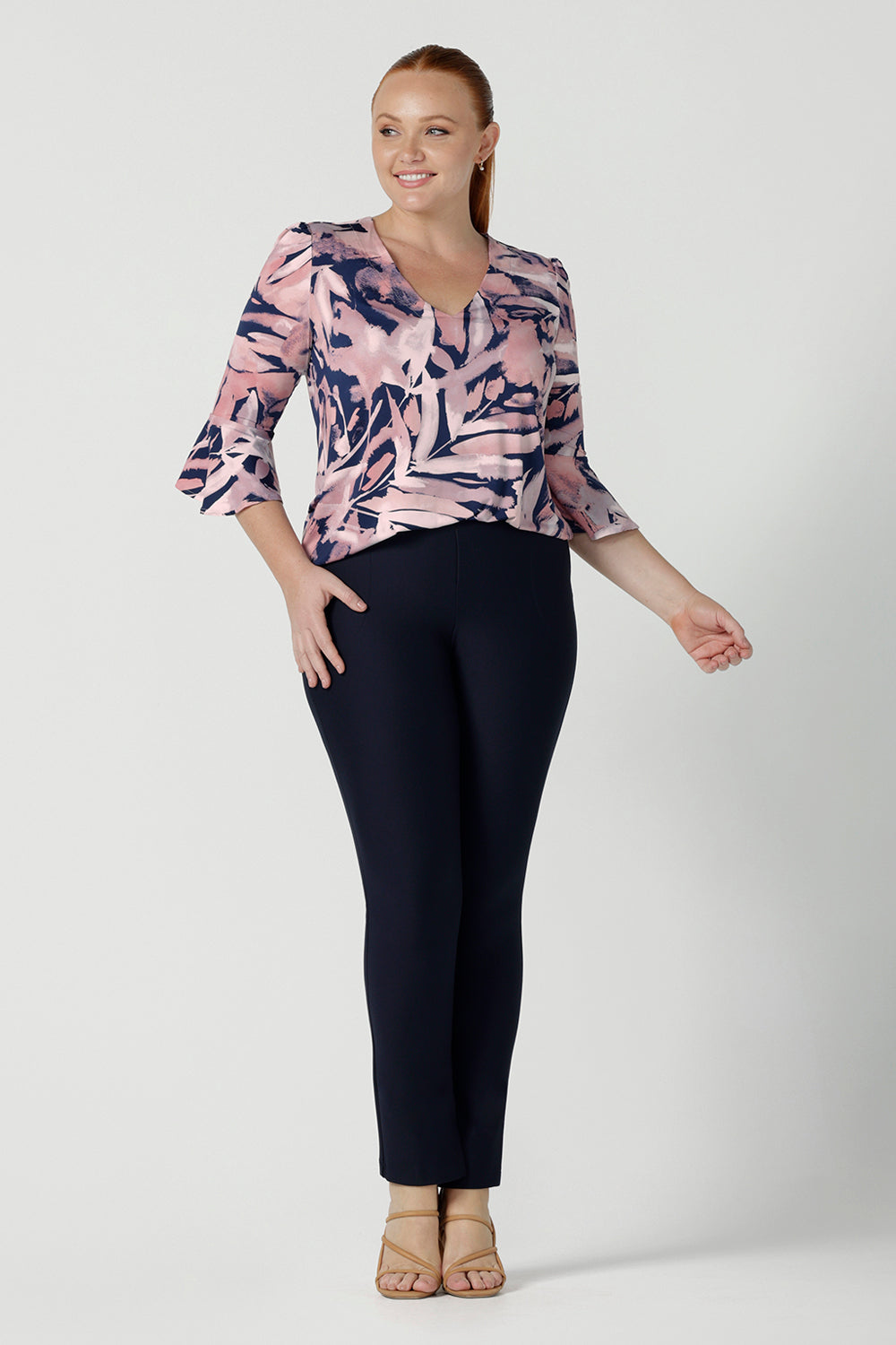 A size 12 woman wears the Tahlia top in Cantata. Fluted sleeves and a v-neckline. A great V-neckline top with 3/4 sleeves. Soft slinky jersey perfect for comfortable workwear for women size 8 - 24.
