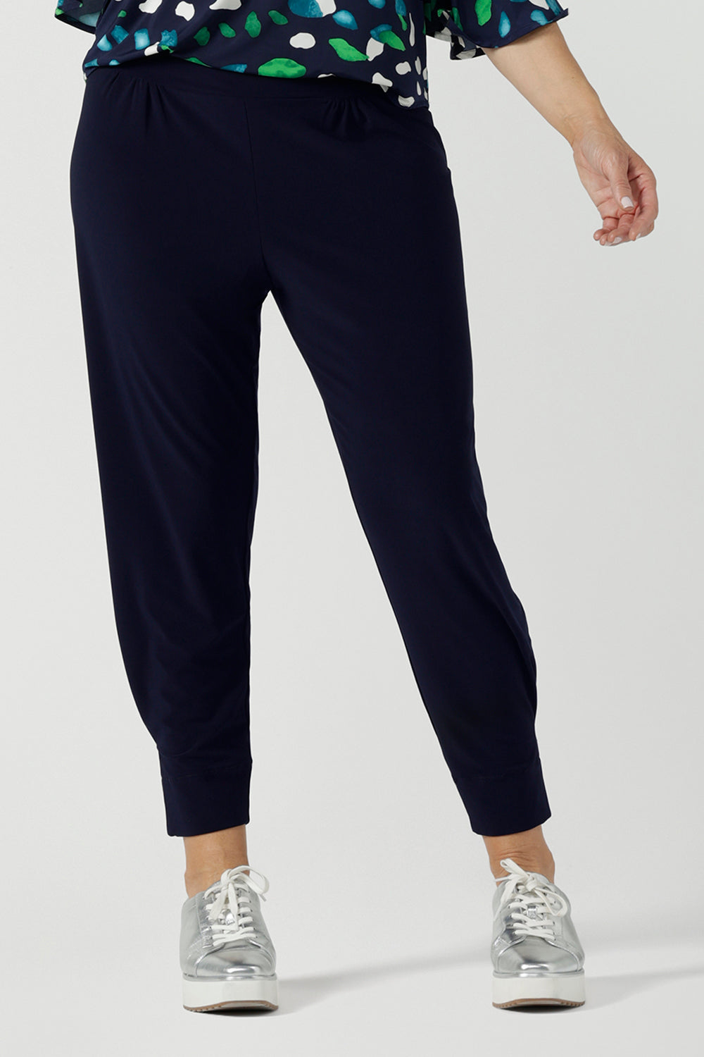 Close up of a size 10 woman wears a Navy Indi pant in jersey. A comfortable pant that is stylish and travel friendly. Made in Australia for women size 8-24. 