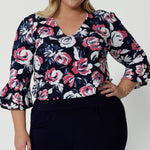 Close up image of plus sized model wearing a V neck floral top. Floral fabric is made of easy care dry touch jersey. 3/4 sleeved top was made in Australia by Australian and New Zealand women. Sizes in this blouse vary from 8-24. Leina and Fleur is woman fashion brand that stocks both petite and plus sizes. Shop now the Tahlia top