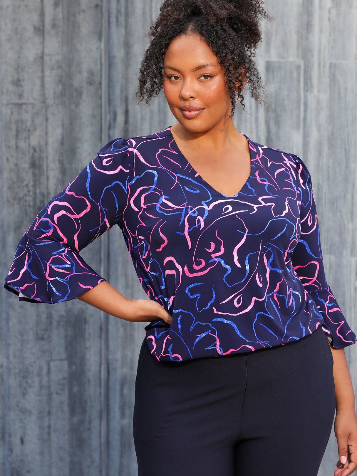 A great top for plus size women, this 3/4 sleeve top with bell cuffs in pink and blue print is by Australian fashion brand, Leina & Fleur. A great women's workwear top, this is one of the new women's tops for spring 2023 and is made in Australia.  
