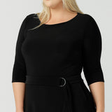 Size 18 woman wears the Melissa dress in black, a belted style with pockets and 3/4 sleeve with rounded boat neckline. Petite to plus size fashion made in Australia for women size 8 - 24.