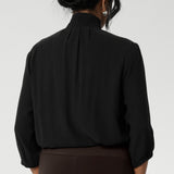 Over 30's woman wears a woven shirt with collar and tailored pleat front. Made from sustainable tencel fabric. Made in Australia for women petite to plus size 8-24. 