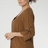 Versatile shirttail hemline allows you to style it tucked in or worn loose, making it perfect for layering from desk to dinner. 