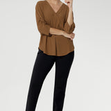 The elegant V-neckline features a tailored tuck at the centre front, while the back is finished with a subtle pleat for a touch of structure and flow. With beautifully ruched ¾ sleeves that fall gracefully toward the front of the arm, the Terry Shirt brings understated detail to a classic silhouette.