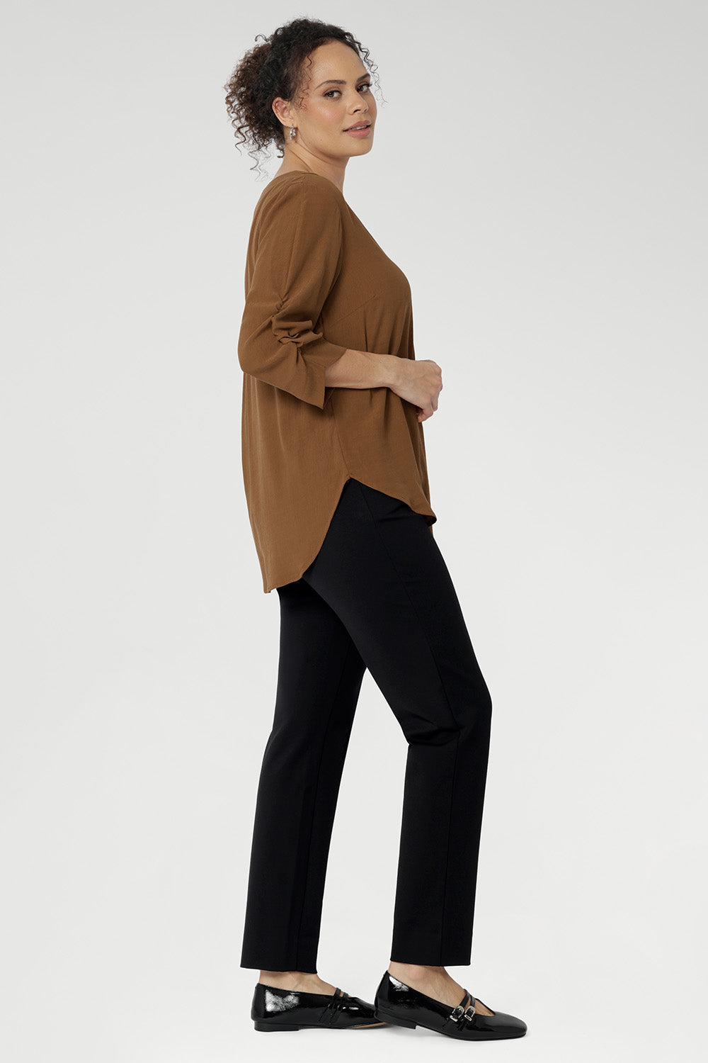  The elegant V-neckline features a tailored tuck at the centre front, while the back is finished with a subtle pleat for a touch of structure and flow. With beautifully ruched ¾ sleeves that fall gracefully toward the front of the arm, the Terry Shirt brings understated detail to a classic silhouette. Available in sizes 8-24.