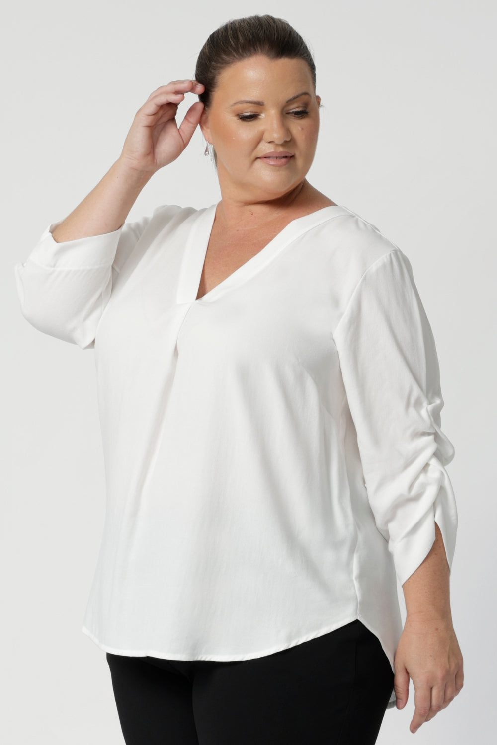 Available in sizes 8 to 24, the Terry Shirt offers a flattering fit for a variety of body types, making it a go-to choice for both style and comfort in the workplace. Plus size wears size 18 Terry Shirt in Vanilla 