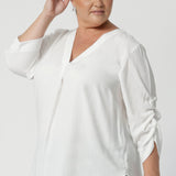 Available in sizes 8 to 24, the Terry Shirt offers a flattering fit for a variety of body types, making it a go-to choice for both style and comfort in the workplace. Plus size wears size 18 Terry Shirt in Vanilla 