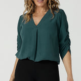 The Terry top in Alpine is a v-neckline shirt with ruched sleeves and a pleat front neckline. Made in Australia for women size 8-24. A comfortable and corporate work shirt that is fashionable and stylish. Made in Australia for size inclusive brand petite to plus size 8-24.