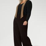 Plus size woman wears woman's easy care top that features neck ties and long sleeves, tucked into her brown high waisted pants. Crafted from our signature dry touch, wrinkle-resistant jersey fabric with an easy care finish that makes it perfect for regular wear.