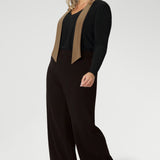Plus size woman wears woman's easy care top that features neck ties and long sleeves, tucked into her brown high waisted pants. Crafted from our signature dry touch, wrinkle-resistant jersey fabric with an easy care finish that makes it perfect for regular wear.