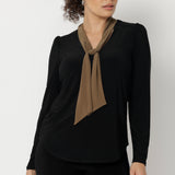 The Thom Top is a refined yet versatile addition to any wardrobe, blending elevated design with everyday ease. This elegant black long-sleeve top features soft coffee-coloured neck ties, offering flexible styling options to suit your day—tie them neatly for a polished office look or leave them open for a more relaxed, event-ready feel.