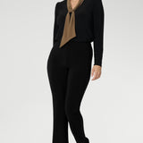 The Thom Top is available in an inclusive size range from 8 to 24, delivering effortless sophistication and comfort for both workwear and special occasions. Size 10 woman wears her Thom Top with black straight leg pants.