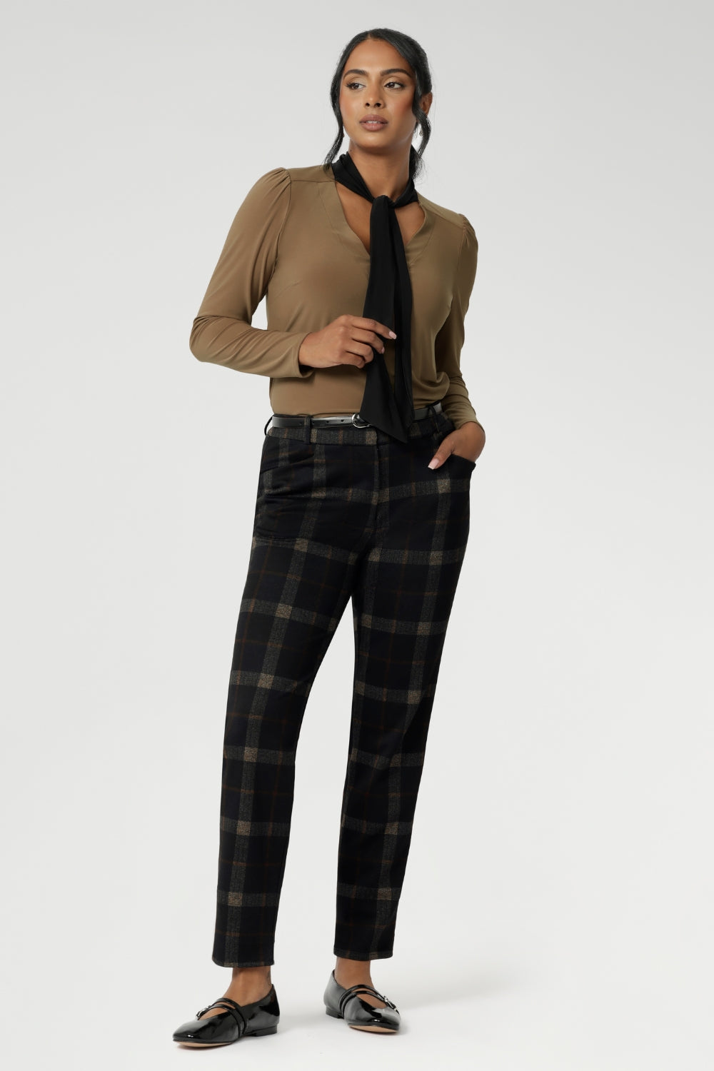 The soft V-neckline is accented by attached neck ties in a warm coffee tone, offering styling versatility—wear them tied for a polished office look or leave them loose for a more relaxed, contemporary feel. Full-length sleeves with gentle gathers at the shoulders add a touch of femininity, while the shoulder yoke and tailored tuck at the back create subtle shape without feeling structured.