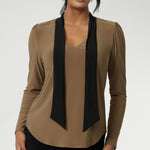 The soft V-neckline is accented by attached neck ties in a warm coffee tone, offering styling versatility—wear them tied for a polished office look or leave them loose for a more relaxed, contemporary feel. Full-length sleeves with gentle gathers at the shoulders add a touch of femininity, while the shoulder yoke and tailored tuck at the back create subtle shape without feeling structured.