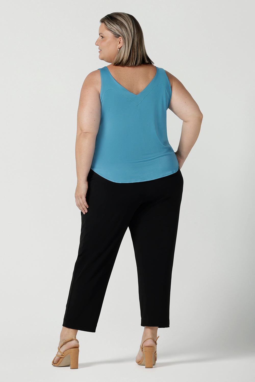 Back view of a size 18 Woman wears the Tobie Pant in Black back with the Eddy Cami in Mineral. These pants are corporate casual pants great for work. Size inclusive corporate clothing for corporate women size 8 - 24.