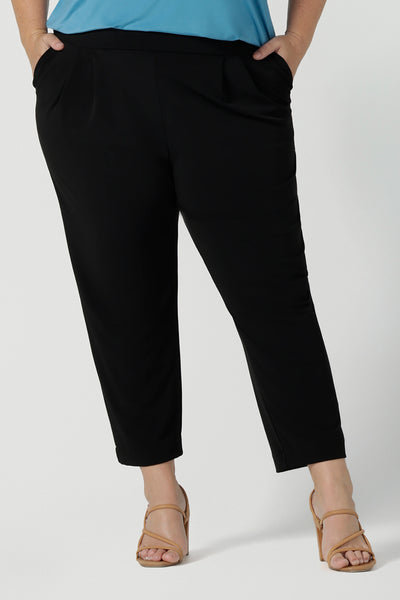 Close up of a curvy size 18 Woman wears the Tobie Pant in Black back with the Eddy Cami in Mineral. These pants are corporate casual pants great for work. Size inclusive corporate clothing for corporate women size 8 - 24.
