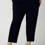 Close up of a size 18 curvy woman wears the Tobie pant in Navy. A comfortable navy work pant with pleat front and pocket detail. Great work pants in soft Jersey. Great for petite to plus size. Made in Australia for women size 8 - 24.