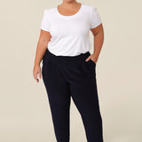 Great pants for travelling, these dropped crotch, trousers with cropped, tapered legs are show for petite height women. Worn with a white bamboo jersey, short sleeve top, these stretchy navy jersey, pull-on trousers are comfortable travel pants that wear well as weekend and casual pants too.