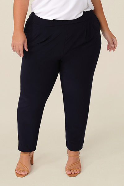 Great pants for travelling, these dropped crotch, trousers have cropped, tapered legs, and are worn with a white bamboo jersey, short sleeve top. In stretch navy jersey, these pull-on trousers are comfortable travel pants that wear well a weekend and casual pants too.