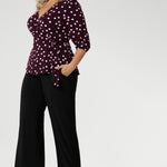 The Tristan wrap top is thoughtfully designed for both comfort and style. Featuring a flattering peplum silhouette, its hemline dips gracefully at the back, offering extra coverage and a feminine touch. The elbow-length bishop sleeves add a hint of volume while maintaining ease of movement, providing coverage through the arms without feeling restrictive.
