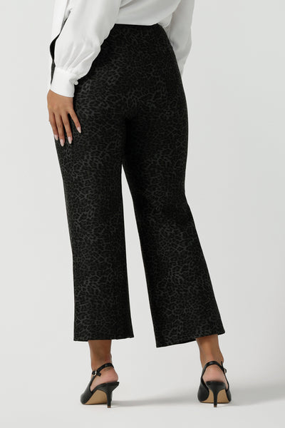 Back view of a stylish woman wears Grey Leopard printed Ponte Troy Pants. A kick flare pant in a fashionable on trend leopard print paired back with a Matisse shirt in white. Made in Australia for women size 8 - 24.