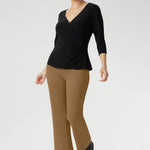 The Uma Pant is crafted from a luxurious caramel dry-touch ponte jersey. This mid-rise, pull-on style features a cropped length, subtle flared leg, and refined front waist pockets for a tailored yet effortless feel. Designed to pair seamlessly with the matching Zander Jacket.