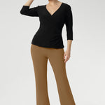 The Uma Pant is crafted from a luxurious caramel dry-touch ponte jersey. This mid-rise, pull-on style features a cropped length, subtle flared leg, and refined front waist pockets for a tailored yet effortless feel. Paired with Kyle Top in Black.