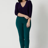 If you're looking for women's work tops look no further than the Vida Top in Amethyst! A V-neck top with 3/4 sleeves, this purple jersey top is worn with tapered leg workwear pants in green. Wear this top with workwear separates as an office top or dress down with casual pants as a comfortable top for the weekend. Made in Australia by Australian and New Zealand women's clothes brand, Leina & Fleur. 