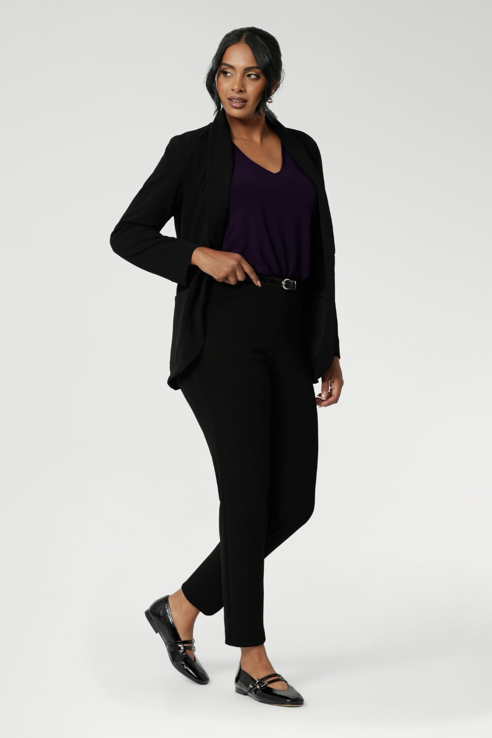 Wear this top with workwear separates as an office top or dress down with casual pants as a comfortable top for the weekend. Size 10 model wears The Vida Top in Amethyst, a V-neck top with 3/4 sleeves with black workwear pants and blazer. Made in Australia by Australian and New Zealand women's clothes brand, Leina & Fleur. 