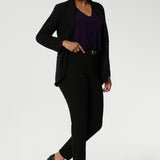 Wear this top with workwear separates as an office top or dress down with casual pants as a comfortable top for the weekend. Size 10 model wears The Vida Top in Amethyst, a V-neck top with 3/4 sleeves with black workwear pants and blazer. Made in Australia by Australian and New Zealand women's clothes brand, Leina & Fleur. 