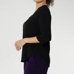 Size 10 woman wearing the Vida top in black that has a V-neckline and 3/4 sleeve. Comfortable dry touch jersey top for corporate workwear to weekend. Made in Australia for women sizes 8-24.