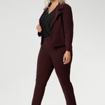 Plus size woman wears the Vida top in black that has a V-neckline and 3/4 sleeve with burgundy suiting set, with matching pants and jacket. Comfortable dry touch jersey top for corporate workwear to weekend wear. Made in Australia for women sizes 8-24. 