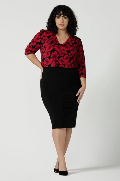 Vida Top with a v-neck and bold poppy floral. Comfortable workwear top for women size 8 - 24. Black base with a red flower. Versatile and comfortable workwear. Styled back with a black slim Andi tube skirt. Made in Australia for women size 8 - 24.