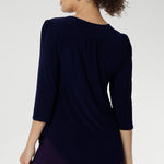 Styled with fluid suiting, the Vida Top creates a polished, professional look while remaining versatile enough for casual wear. Shown from the back, the clean lines and refined silhouette highlight its easy fit and timeless appeal. Proudly made in Australia and available in inclusive sizes 8 to 24.