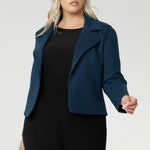 Plus size woman wears knit top under her Garcia Jacket in Petrol. Designed for comfort and versatility, it features a flattering close-to-body fit that moves with you, thanks to its generous stretch and breathable finish. Black knit top has thumbholes that can be used or tucked away for versatility in styling and extra warmth. Available in size 8-24.