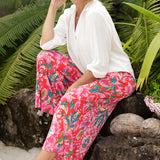 These women's printed pants are a stunning combination of style, comfort, and practicality, designed for the modern woman on the go. Featuring a bold abstract summer design in bright, vibrant colours, they capture the essence of the season with a playful yet sophisticated flair. Made from lightweight crepe jersey fabric, these pants offer a smooth, breathable fit that moves effortlessly with you, making them perfect for travel or long days spent out and about.