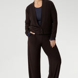 Mature aged model wears Monroe Pants in Cocoa. Crafted from a luxe jersey fabric that drapes beautifully and offers all-day comfort. It pairs perfectly with other pieces from our fluid suiting collection.