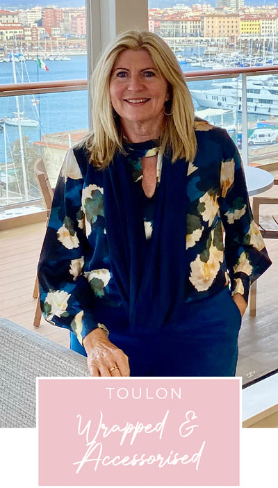 Loyal customer of Australian and New Zealand women's clothing label, L&F, Susan wears a floral print, satin rayon shirt with tie neckline and long bishop sleeves as dinner-date wear on a European cruise holiday, as part of her guide on for 40 plus women on what clothes to pack for the ultimate capsule travel wardrobe.