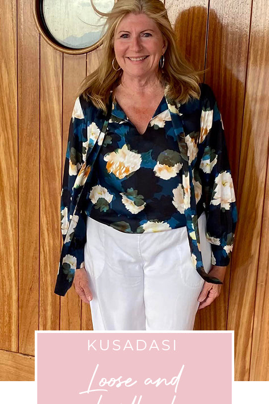 Loyal customer of Australian and New Zealand women's clothing label, L&F, Susan wears a floral print, satin rayon shirt with tie neckline and long bishop sleeves as going out to dinner wear on a European cruise holiday, as part of her guide on what clothes to pack for the ultimate capsule travel wardrobe.