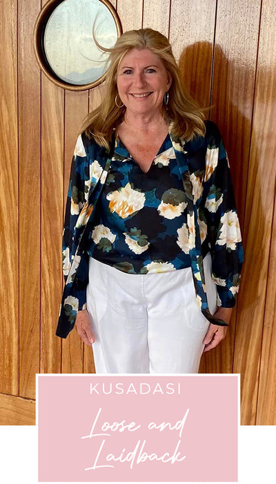 Loyal customer of Australian and New Zealand women's clothing label, L&F, Susan wears a floral print, satin rayon shirt with tie neckline and long bishop sleeves as going out to dinner wear on a European cruise holiday, as part of her guide on what clothes to pack for the ultimate capsule travel wardrobe.
