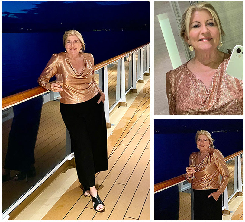 Image of an Australian woman wearing a long sleeve, cowl neck top in glitzy, antique sparkly fabric with wide leg black pants, all by Australian and New Zealand women's clothing label, L&F, as part of her guide to the ultimate capsule travel wardrobe. She is wearing L&Fs glamorous eveningwear top for dinner on her European cruise.